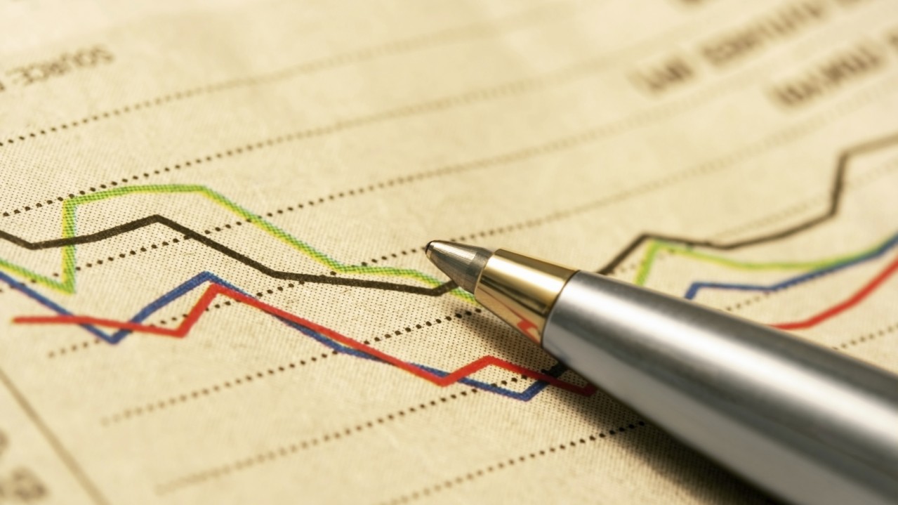 Ballpoint pen resting on stockmarket graph