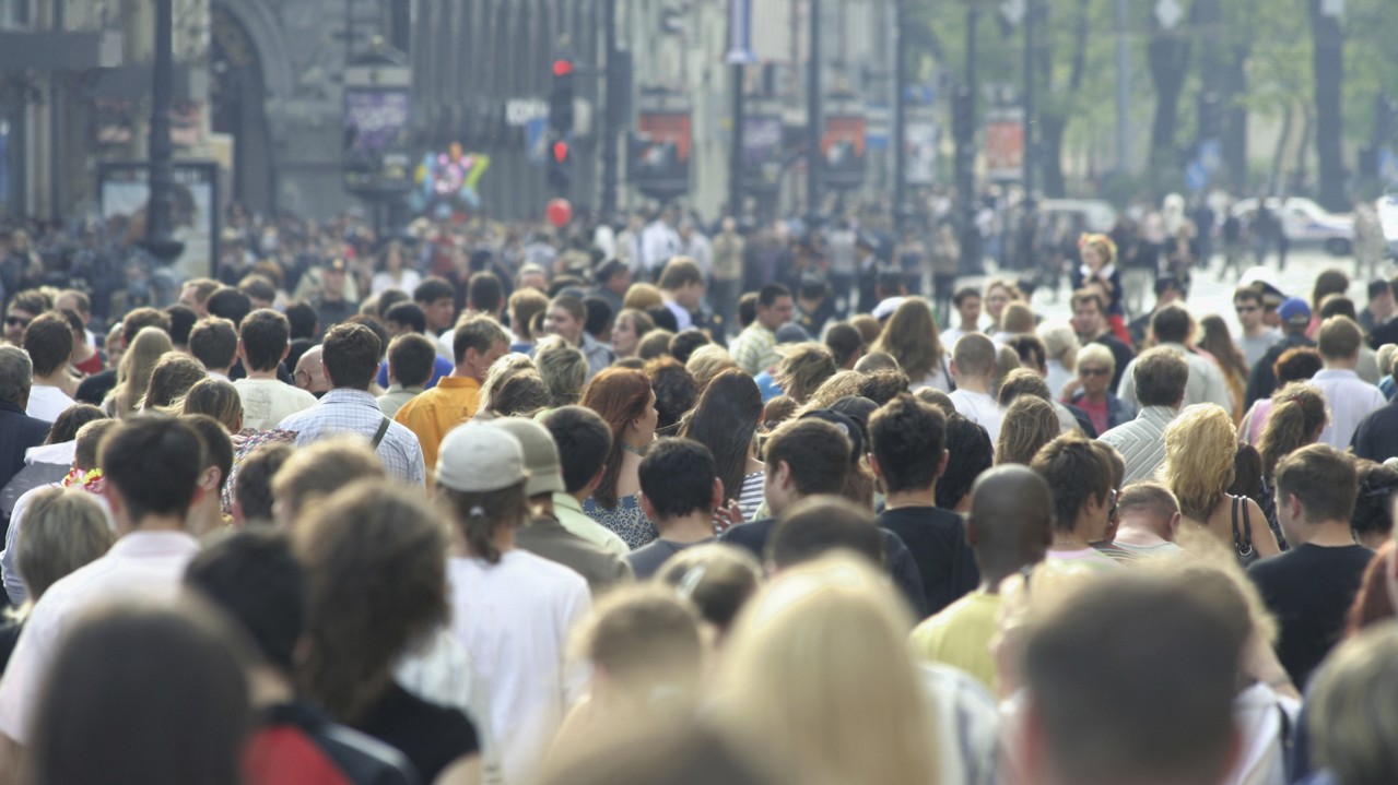 Crowd of people walking in city