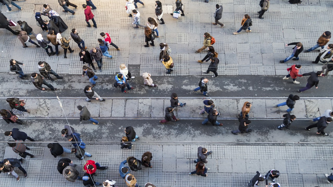 people crossing street arial view