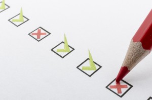 Close up of red pencil marking checkbox with a cross