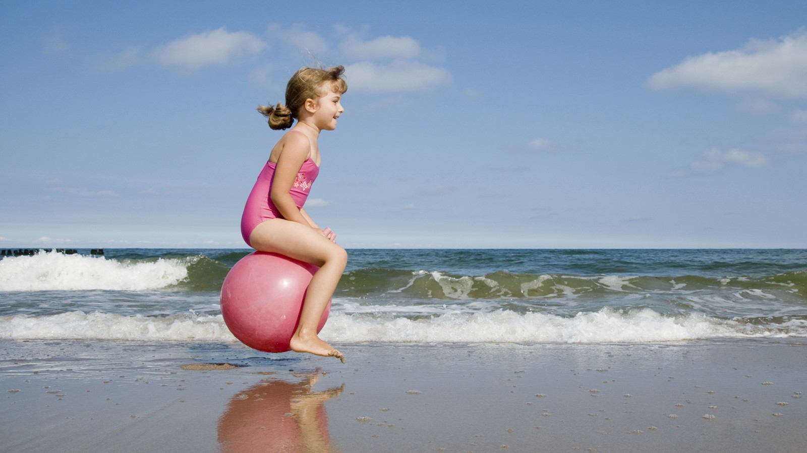 Child bouncing on a beach