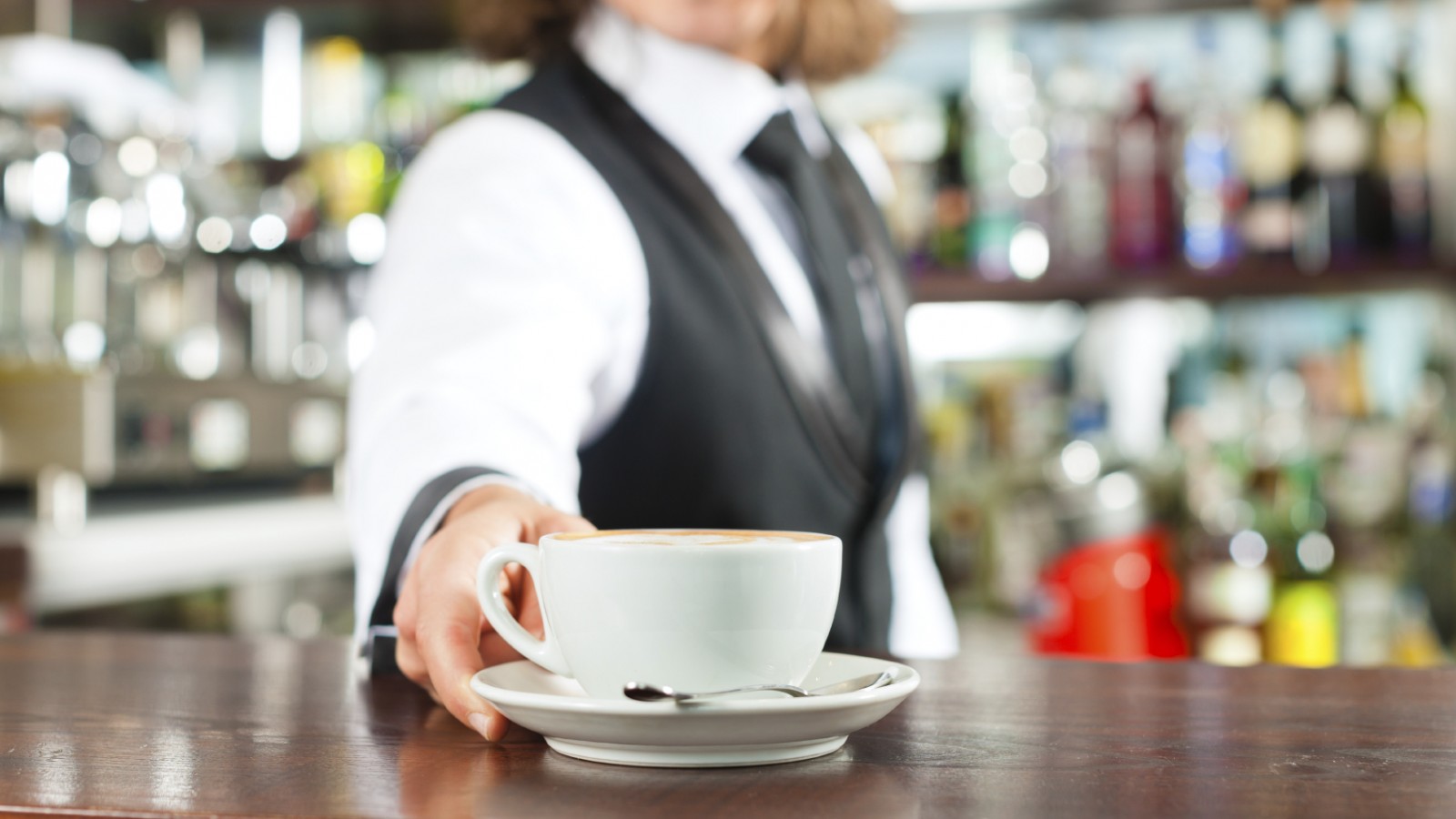 Barista making cappuccino in coffeeshop